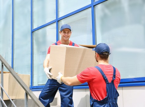 Man with van removal service loading furniture for a local move in Removalservices