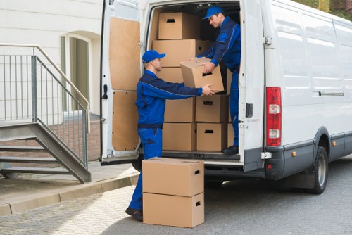 Professional movers loading furniture and boxes for a house move