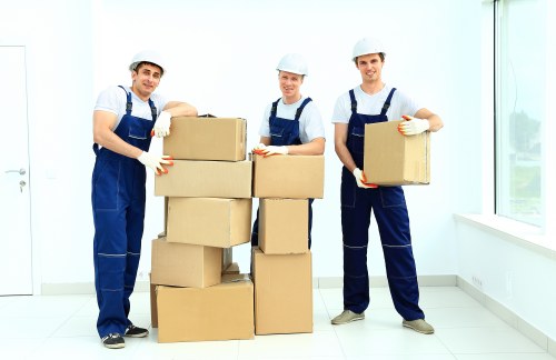 Removal team preparing belongings with safety equipment and careful handling