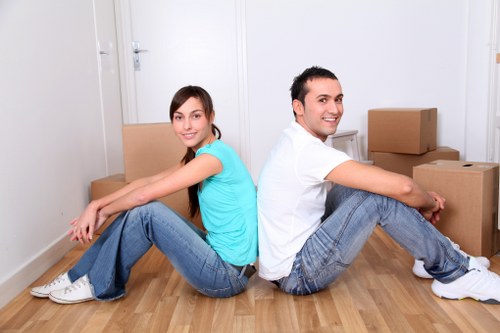 Loading furniture into a removal van on a narrow residential street