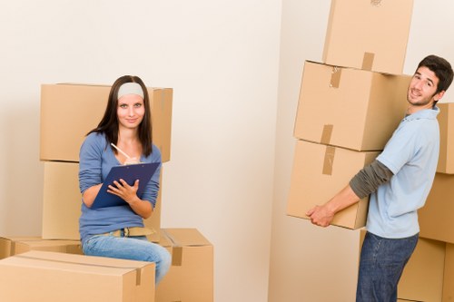 Professional movers handling desks and office equipment carefully